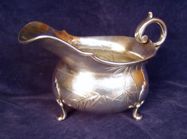 Sauceboat on three cast feet w/hollow C scroll handle